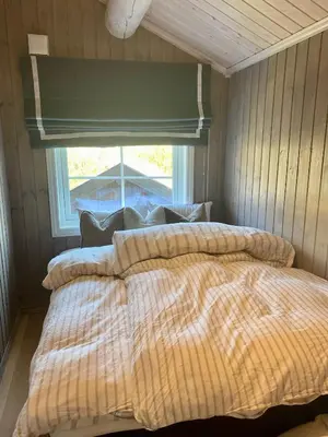 a bedroom with two beds and a window at Bjarnebu - 4 bedroom cabin in Rauland in Rauland