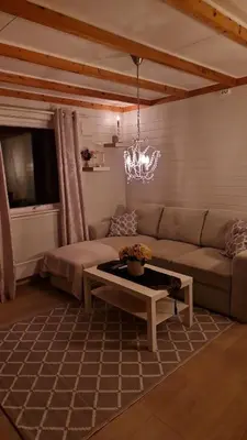 a living room with a couch and a table at Apartment in peacefull surroundings in Ådnavik