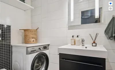 a white bathroom with a washing machine and a sink at The best place to stay in city center - close to everything in Bergen