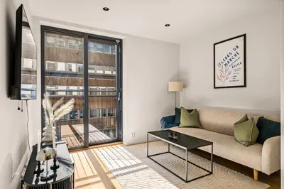 a living room with a couch and a table at Downtown Modern Apartment - Two Bedrooms! in Bergen