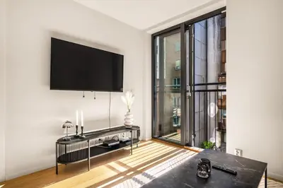 a living room with a flat screen tv on a wall at Downtown Modern Apartment - Two Bedrooms! in Bergen