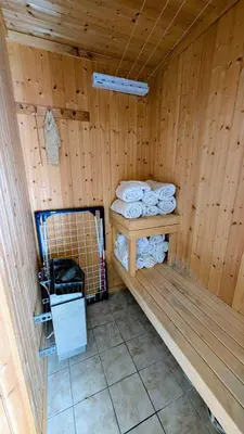 a sauna with folded towels in a wooden room at Soltoppen - cozy 3 bedroom cabin close to Norefjell