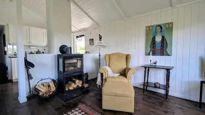 a living room with a chair and a fireplace at Soltoppen - cozy 3 bedroom cabin close to Norefjell