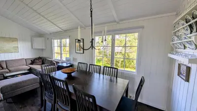 a dining room with a table and a couch at Soltoppen - cozy 3 bedroom cabin close to Norefjell