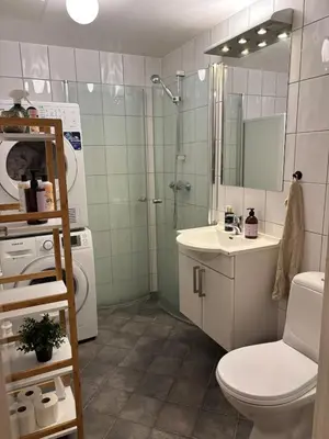 a bathroom with a shower and a toilet and a sink at Stay in the middle of Bergen city centre! in Bergen