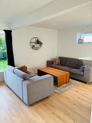 a living room with two couches and a coffee table at Large and bright apartment, perfect base in autumn in Ålesund