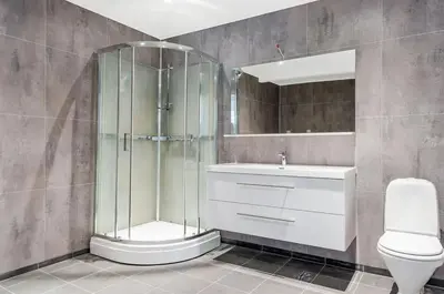 a bathroom with a shower and a toilet and a sink at Large and bright apartment, perfect base in autumn in Ålesund