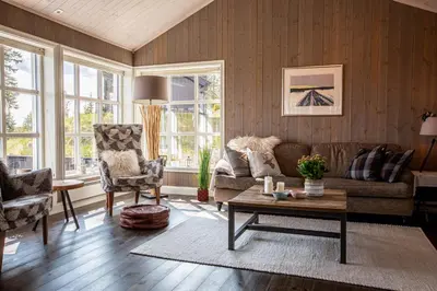 a living room with a couch and a table at Valdreshytte med peis Klassisk og lun stil in Aurdal