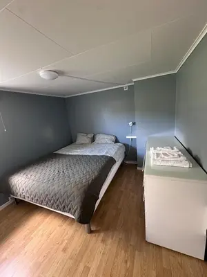 a small bedroom with a bed and a desk at Basement apartment in beautiful Volda in Volda