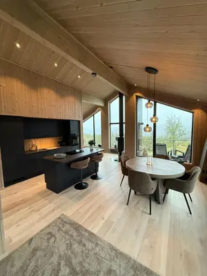 a kitchen and dining room with a table and chairs at Exclusive cabin with sauna and mountain view in Geilo in Hol