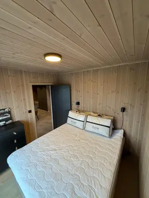 a bed in a room with two boxes on it at Exclusive cabin with sauna and mountain view in Geilo in Hol