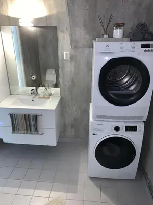 a bathroom with a washing machine and a sink at Bright and nice apartment in Kristiansund