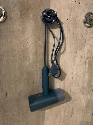 a blue object with a cord on the floor at Bright and nice apartment in Kristiansund