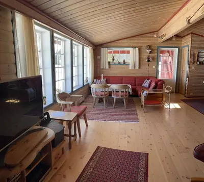 a living room with a couch and a table at Very central and by the lake Sjusjøen in Ringsaker