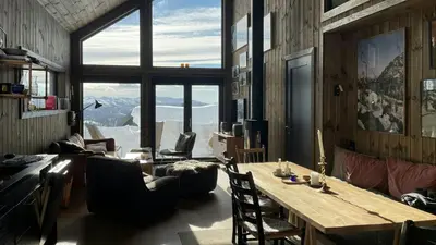 a room with a table and chairs and a large window at Modern Cabin With Mountain Views In Rauland in Rauland