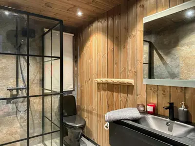 a bathroom with a sink and a glass shower at Modern Cabin With Mountain Views In Rauland in Rauland