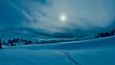 a moon rising over a snow covered field with the sun at Modern Cabin With Mountain Views In Rauland in Rauland
