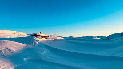 a house is covered in snow in front at Modern Cabin With Mountain Views In Rauland in Rauland