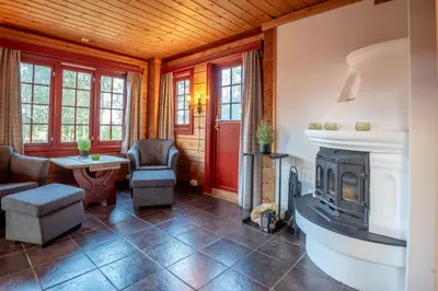 a living room with a fireplace and a table and chairs at Lisetra 716B in Trysil