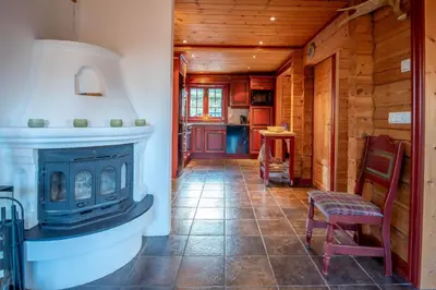 a living room with a fireplace in a log cabin at Lisetra 716B in Trysil