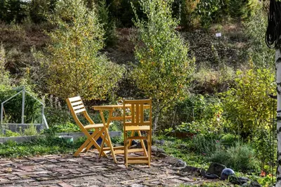 two chairs and a table in a garden at Family Cabin With Views Over Hadeland in Lunner