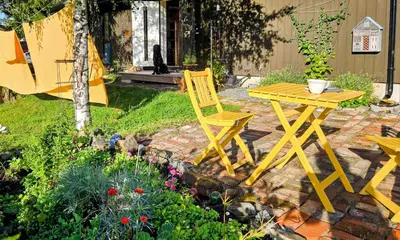 a yellow table and chair in a garden at Family Cabin With Views Over Hadeland in Lunner