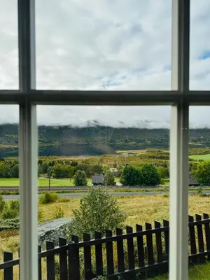 a window view of a field from a farm house at Fjellro-Geilo Cabin Retreat in Geilo