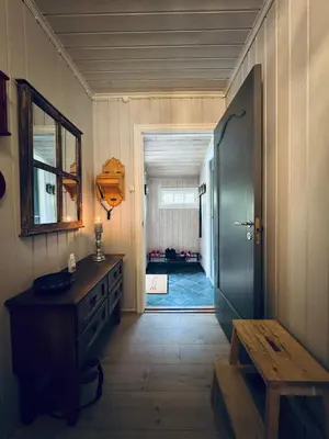 a hallway with a door to a room with a sink and a table at Fjellro-Geilo Cabin Retreat in Geilo