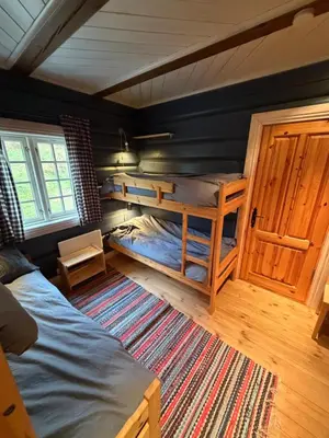 a room with two bunk beds in a room at Log cabin at Hafjell in Øyer