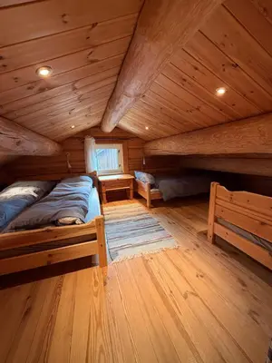 a room with two beds in a log cabin at Log cabin at Hafjell in Øyer