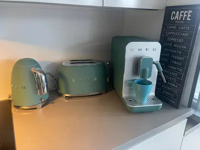 three toasters sitting on a counter next to a sign at Sentrumsnær leilighet Bergen in Bergen