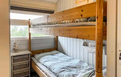a bedroom with two bunk beds in a room at Gorgeous Home In Lavik With House Sea View in Lavik
