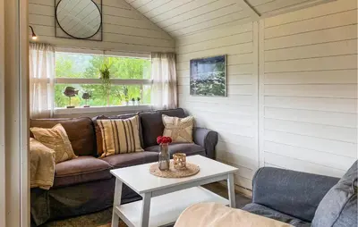 a living room with a couch and a table at Gorgeous Home In Lavik With House Sea View in Lavik