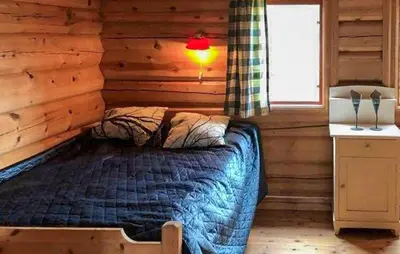 a bedroom with a bed in a log cabin at Stunning Home In Oppdal With Sauna in Oppdal