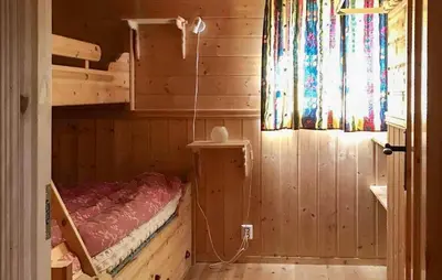 a bedroom with a bed in a wooden cabin at Stunning Home In Oppdal With Sauna in Oppdal