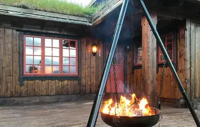a fire pit in front of a building at Stunning Home In Oppdal With Sauna in Oppdal