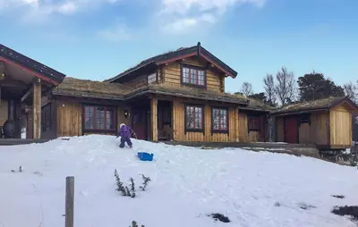 a person standing in the snow in front of a house at Stunning Home In Oppdal With Sauna in Oppdal