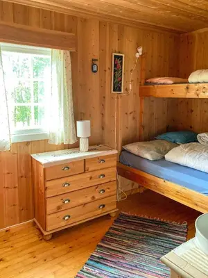 a bedroom with two bunk beds and a window at Simple Mountain Cabin Near Vinstra in Vinstra