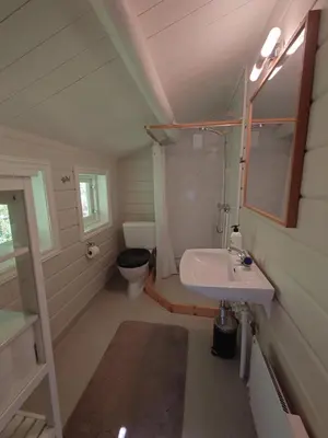 a small bathroom with a sink and a toilet at Mountain view cabin in Torvik