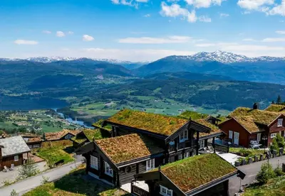 a view of a village with mountains in the background at Log Cabin With Panoramic Views At Voss Resort in Skulestadmo