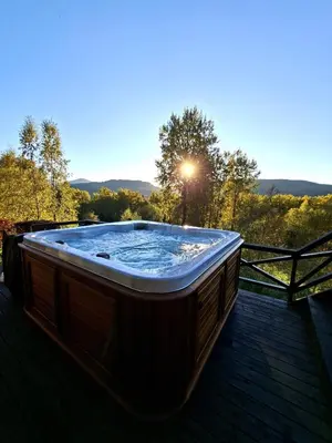 a hot tub sitting on top of a wooden deck at Moderne hytte på Tingvoll nær sjø og turterreng in Tingvoll