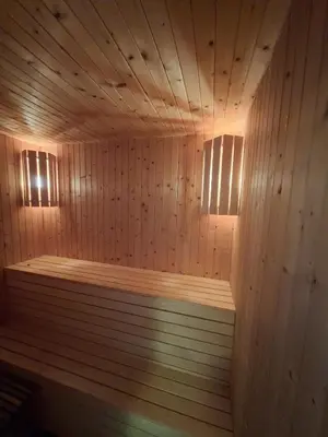 a large wooden sauna with two lights on it at Moderne hytte på Tingvoll nær sjø og turterreng in Tingvoll