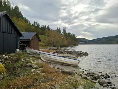 two boats on the shore of a body of water at Moderne hytte på Tingvoll nær sjø og turterreng in Tingvoll
