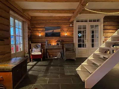 a room with a staircase in a wooden house at Charming house by the fjord in Utvik