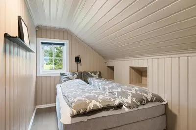 a bedroom with a bed and a window at Lingåsen Panorama! in Valldal