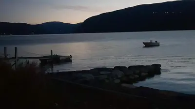 a boat in the water near a dock at House with oceanview in Stryn
