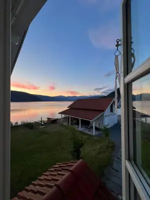 a view from a window of a house with a lake at House with oceanview in Stryn