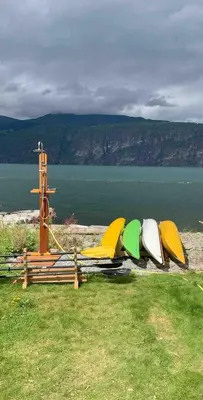 a group of surfboards lined up next to the water at House with oceanview in Stryn