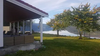 a porch of a house with a view of a lake at House with oceanview in Stryn