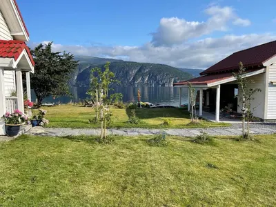 a house with a yard with a view of a lake at House with oceanview in Stryn